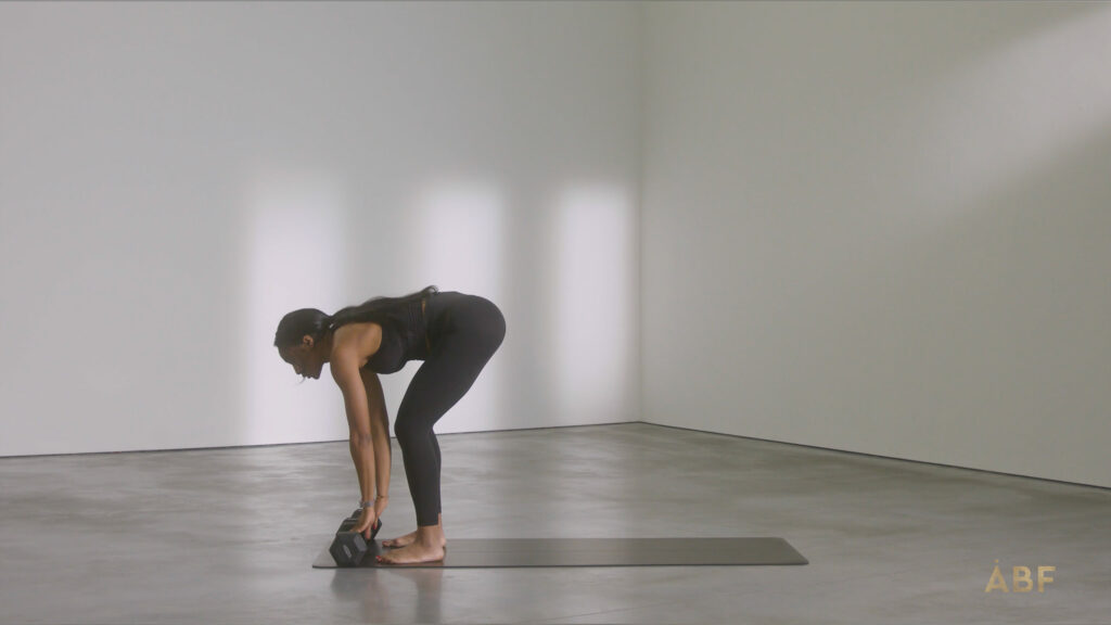 Woman picking up weights