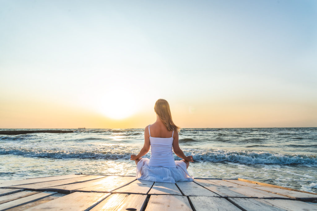 Woman,Meditating,At,The,Sea